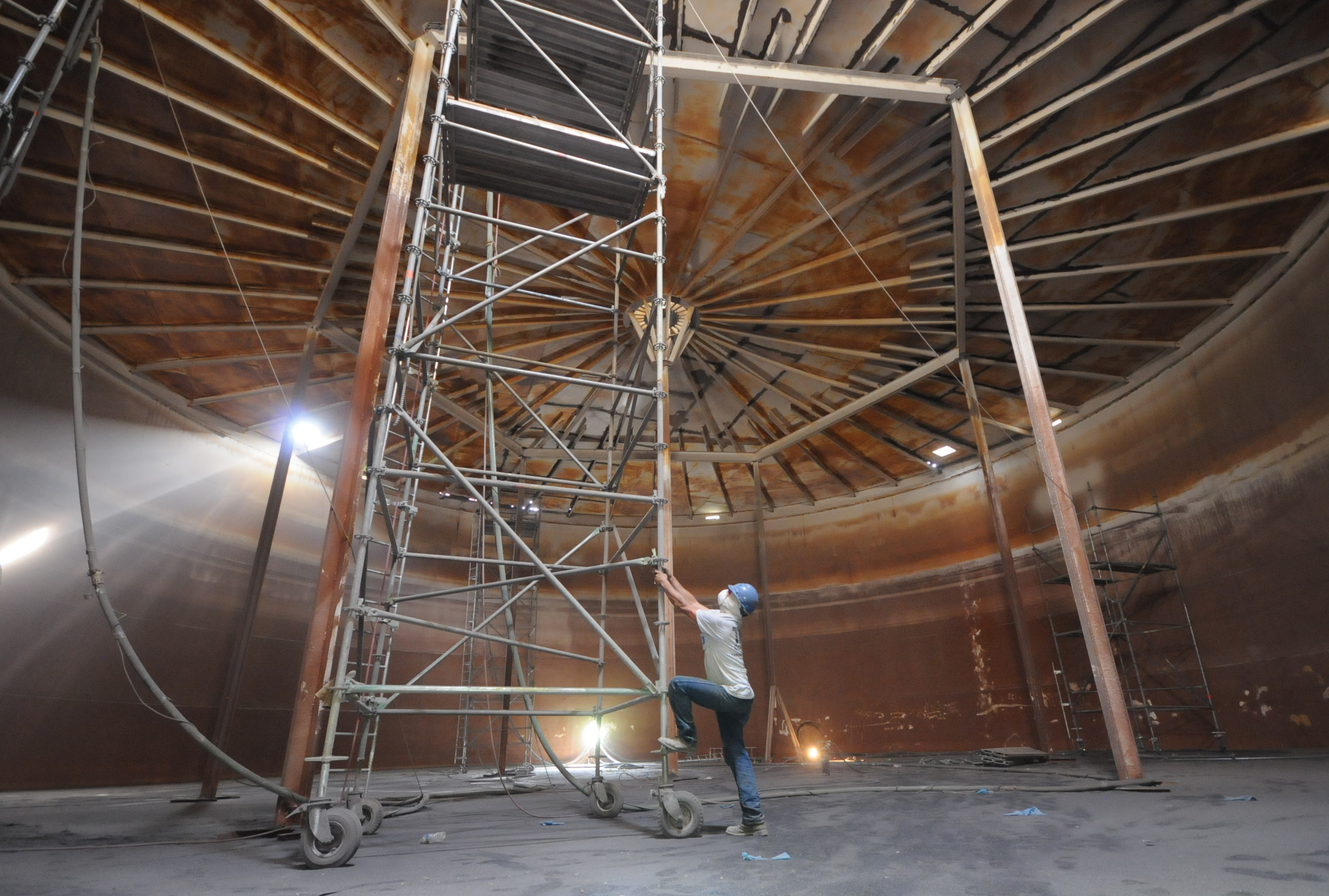 Staff Photo by Tim Barber/Chattanooga Times Free Press - June 14, 2012 - TMI Coatings employee, Mike Sokolowki, begins to climb up scaffolding inside the Tennessee American Water Company's 1.8 million-gallon water storage tank Thursday as work continues sand blast, then paint the container for usage. The interior crew of four use air-fed helmets, respirators and air purifiers while working, according to Stuart Griffis.
