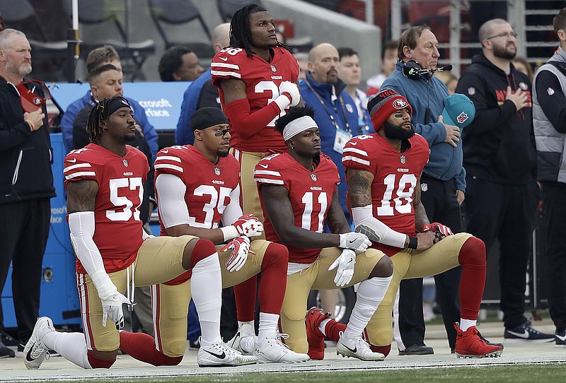 
              FILE - In this Dec. 24, 2017, file photo, San Francisco 49ers outside linebacker Eli Harold, from bottom left, kneels with safety Eric Reid, wide receiver Marquise Goodwin and wide receiver Louis Murphy during the national anthem before an NFL football game against the Jacksonville Jaguars in Santa Clara, Calif. The NFL Players Association filed a grievance with the league challenging its national anthem policy. The union says that the new policy, which the league imposed without consultation with the NFLPA, is inconsistent with the collective bargaining agreement and infringes on player rights. (AP Photo/Marcio Jose Sanchez, File)
            
