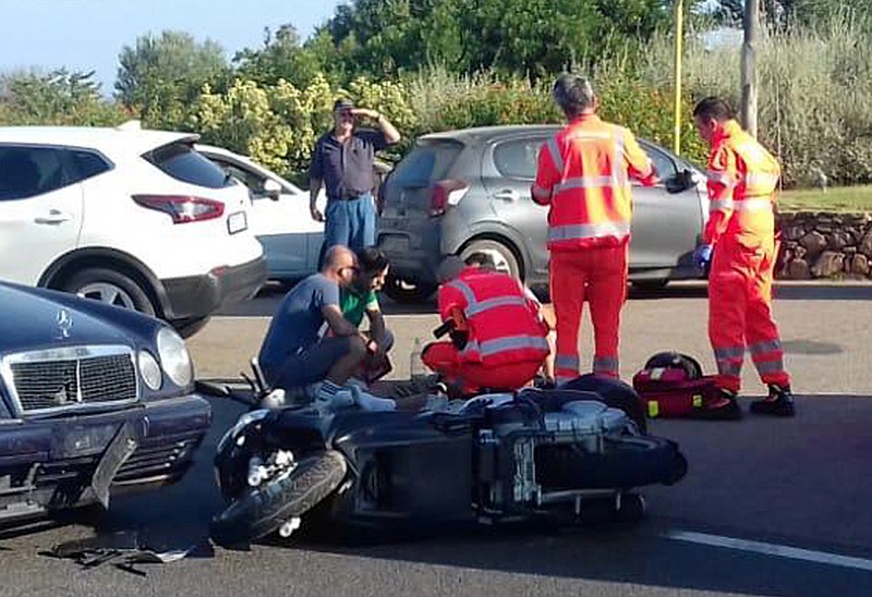 Ambulance personnel tend to a man lying on the ground, later identified as actor George Clooney, after being involved in a scooter accident in the near Olbia, on the Sardinia island, Italy, Tuesday, July 10, 2018. 