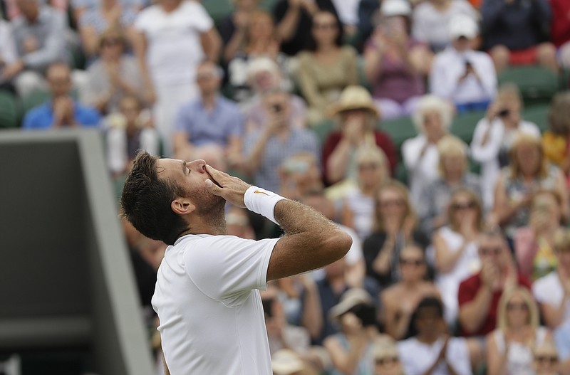 
              Juan Martin Del Potro of Argentina celebrates defeating Gilles Simon of France in their men's singles match at the Wimbledon Tennis Championships in London, Tuesday July 10, 2018. (AP Photo/Kirsty Wigglesworth)
            