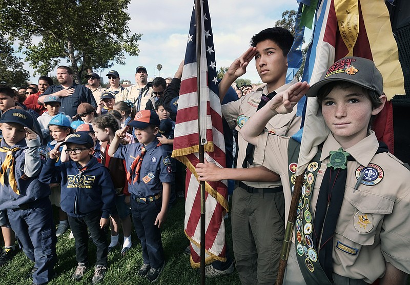 Boy Scouts and Cub Scouts salute the flag during Memorial Day weekend ceremonies at the Los Angeles National Cemetery. Boy Scouts of America and the Summit Bechtel Reserve are teaming up for a new national education program for young hunters. / Associated Press photo