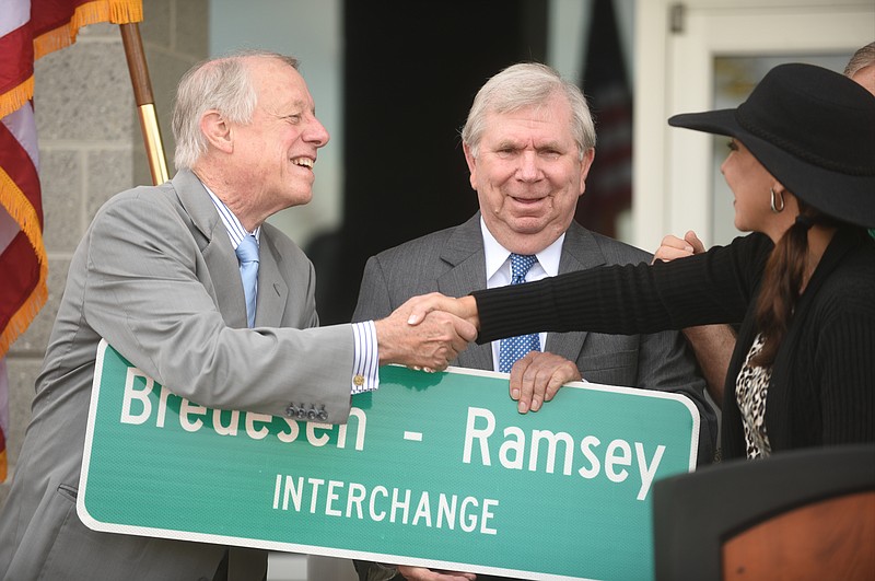 Former Governor Phil Bredesen, left, is greeted by Hamilton County Commissioner Sabrena Smedley, right, as former Hamilton County Mayor Claude Ramsey looks on during an October 2015 event naming the exit 9 Interchange on I-75 after Bredesen and Ramsey. The exit is near the Volkswagen plant at Enterprise South.