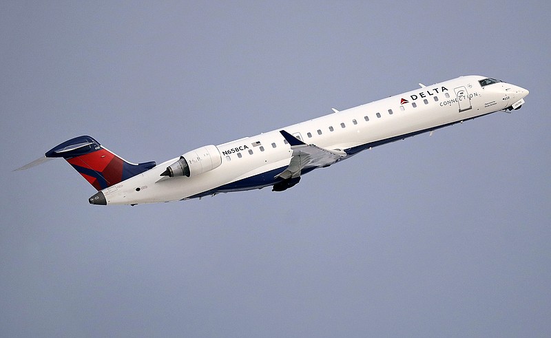 FILE- In this Jan. 8, 2018, file photo, a Delta Air Lines Connection regional jet operated by GoJet Airlines takes off from Logan International Airport in Boston. Delta Air Lines reports earns on Thursday, July 12. (AP Photo/Charles Krupa, File)