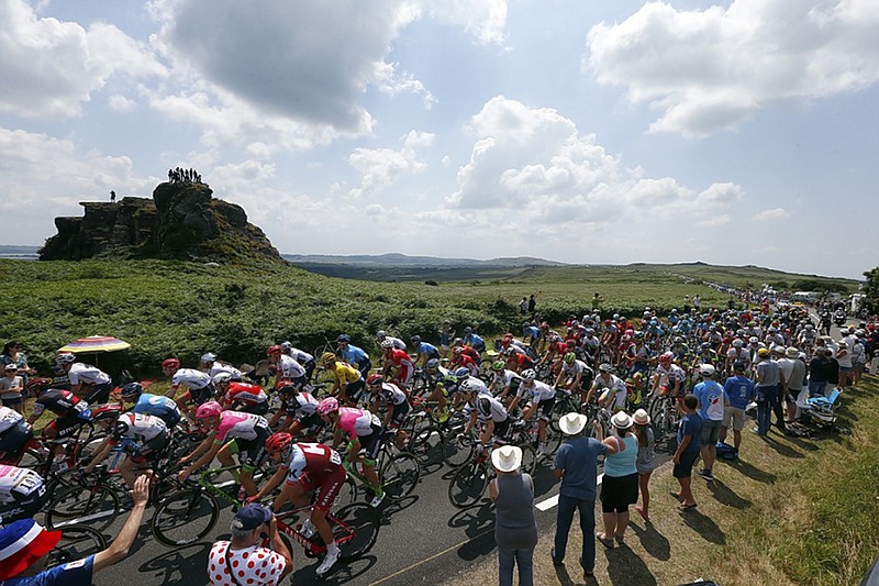 The pack rides past fans during the sixth stage of the Tour de France on Thursday. The 112.5-mile stage, which included four climbs, started in Brest and finished in Mur de Bretagne.