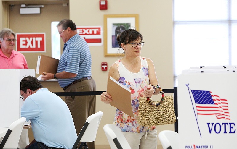 Lynn Seeger of Red Bank, Tennessee, picks out a spot to sit down a fill out her ballot at the Hamilton County Election Commission Friday, July 13, 2018 in Chattanooga, Tennessee. Seeger said that she will be out of town for election day, so she wanted to go early to make sure she voted during the early voting time. 