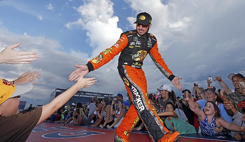 Martin Truex Jr. greets fans before the NASCAR Cup Series race last Saturday night at Daytona International Speedway in Daytona Beach, Fla.