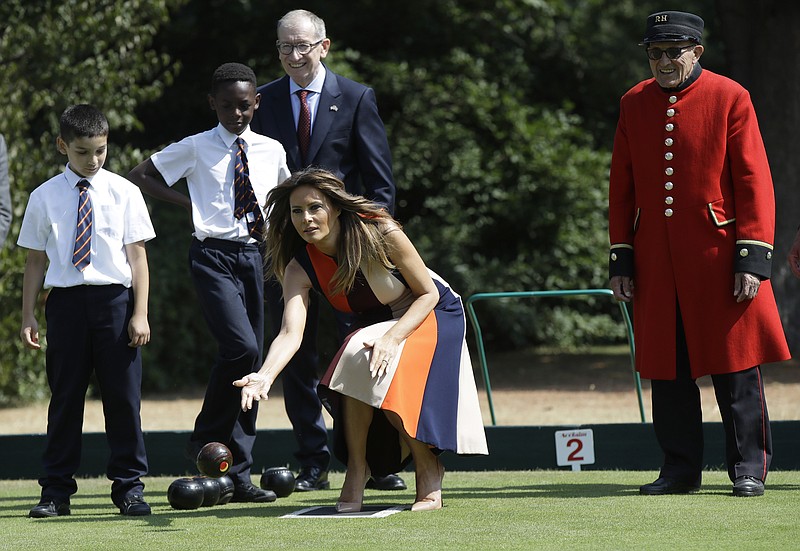 U.S. First Lady Melania Trump plays bowls she meets British military veterans known as "Chelsea Pensioners" at The Royal Hospital Chelsea in central London Friday, July 13, 2018. 