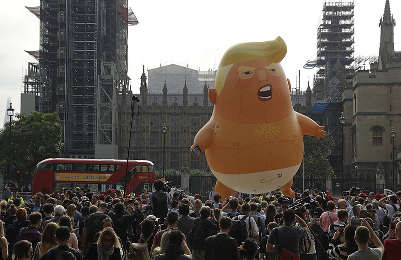A six-meter high cartoon baby blimp of U.S. President Donald Trump is flown as a protest against his visit, in Parliament Square backdropped by the scaffolded Houses of Parliament and Big Ben in London, England, Friday, July 13, 2018. Trump is making his first trip to Britain as president after a tense summit with NATO leaders in Brussels and on the heels of ruptures in British Prime Minister Theresa May's government because of the crisis over Britain's exit from the European Union. (AP Photo/Matt Dunham)