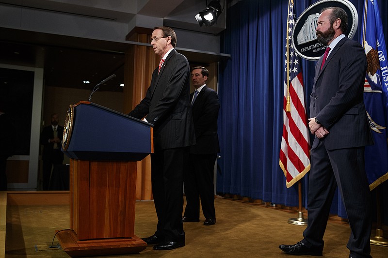 Deputy Attorney General Rod Rosenstein speaks at a news conference at the Department of Justice, Friday, July 13, 2018, in Washington. From left, Assistant Attorney General John Demers, Rosenstein, and Acting Principal Associate Deputy Attorney General Ed O'Callaghan. (AP Photo/Evan Vucci)
