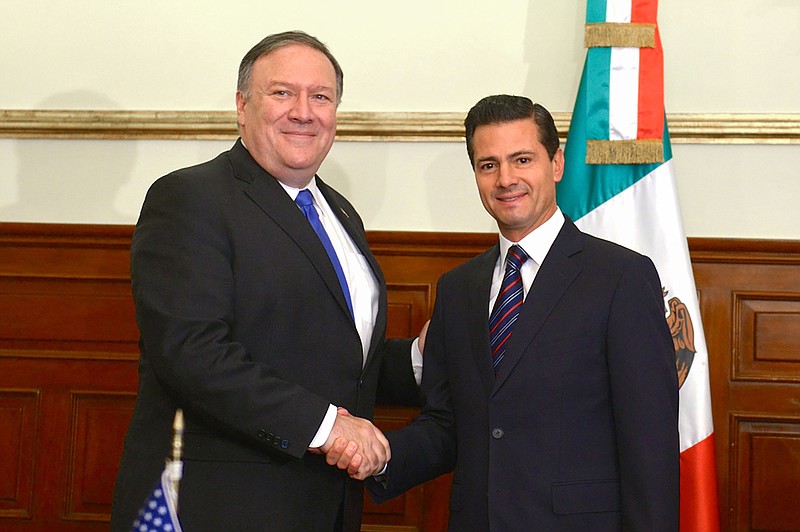 In this photo released by Mexico's Presidential Press Office, Secretary of State Mike Pompeo and Mexico's President Enrique Pena Nieto, pose for a photo at Los Pinos presidential residence in Mexico City, Friday, July 13, 2018.