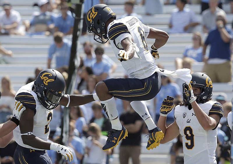 Demetris Robertson leaps in celebration as California teammates Jordan Duncan, left, and Kanawai Noa look on during the Golden Bears' win at North Carolina in September 2017. Robertson, injured much of last season after a strong freshman year at Cal, is returning to his home state, transferring to play for the Georgia Bulldogs.