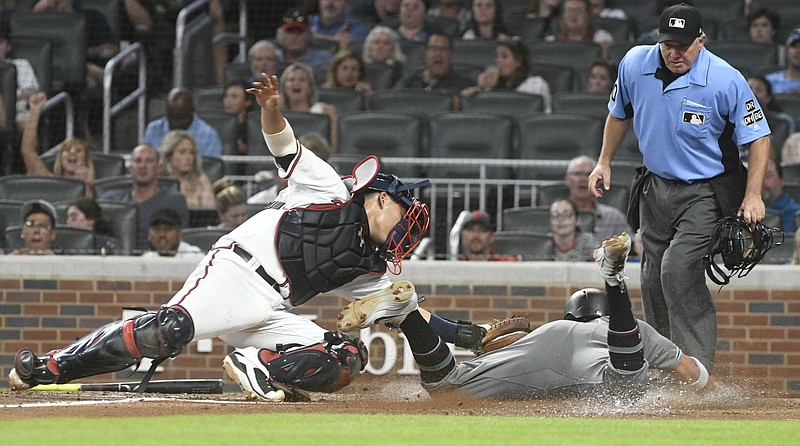 Atlanta Braves catcher Kurt Suzuki, left, tags out the Arizona Diamondbacks' Jon Jay at home plate in the sixth inning of Friday night's game at SunTrust Park in Atlanta. Arizona won 2-1 as the Braves los for the seventh time in their past nine games.