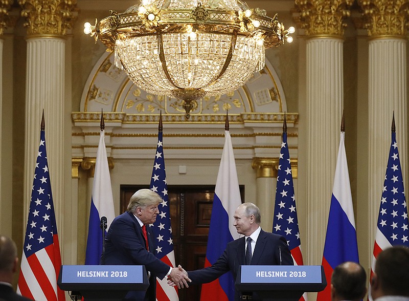 U.S. President Donald Trump, left, shakes hand with Russian President Vladimir Putin during a press conference after their meeting at the Presidential Palace in Helsinki, Finland, Monday, July 16, 2018. (AP Photo/Alexander Zemlianichenko)