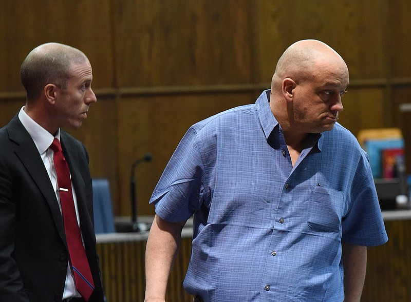 At the outset of his murder trial, Randall Reed, right, takes his seat alongside attorney Fisher Wise, left, Tuesday in Judge Tom Greenholtz's courtroom.