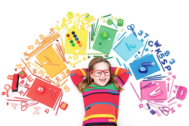 A little girl with school supplies, books, drawing and painting tools and materials. Getty Images/iStockphoto/FamVeld