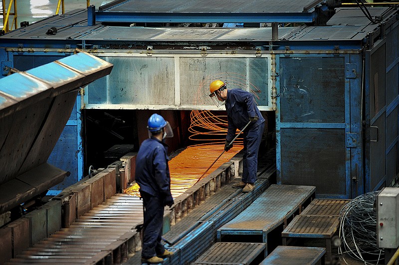 In this June 8, 2018, photo, a worker handles red hot steel cables at a steel factory in Qingdao in east China's Shandong province. The Trump administration on Monday, July 16, 2018, brought cases against China, the European Union, Canada, Mexico and Turkey at the World Trade Organization for retaliating against American tariffs on imported steel and aluminum. (Chinatopix via AP)