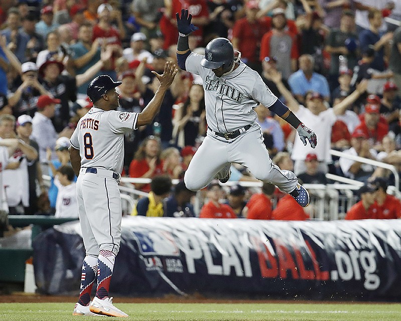 Seattle Mariners shortstop Jean Segura (2) celebrates his three-run homer in the eighth inning during the Major League Baseball All-star Game, Tuesday, July 17, 2018 in Washington. (AP Photo/Alex Brandon)

