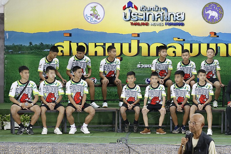 Members of the rescued soccer team and their coach sit during a press conference discussing their ordeal in the cave in Chiang Rai, northern Thailand, Wednesday, July 18, 2018. The 12 boys and their soccer coach rescued after being trapped in a flooded cave in northern Thailand are recovering well and are eager to eat their favorite comfort foods after their expected discharge from a hospital soon. (AP Photo/Vincent Thian)