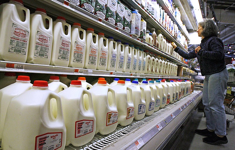 In this Feb. 11, 2009, file photo, a shopper looks over the milk aisle at the Hunger Mountain Co-op in Montpelier, Vt. (AP Photo/Toby Talbot, File)