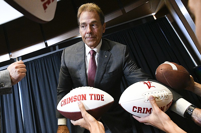 Fans seek autographs from NCAA college football head coach Nick Saban of Alabama during the Southeastern Conference Media Days at the College Football Hall of Fame in Atlanta, Wednesday, July 18, 2018. (AP Photo/John Amis)