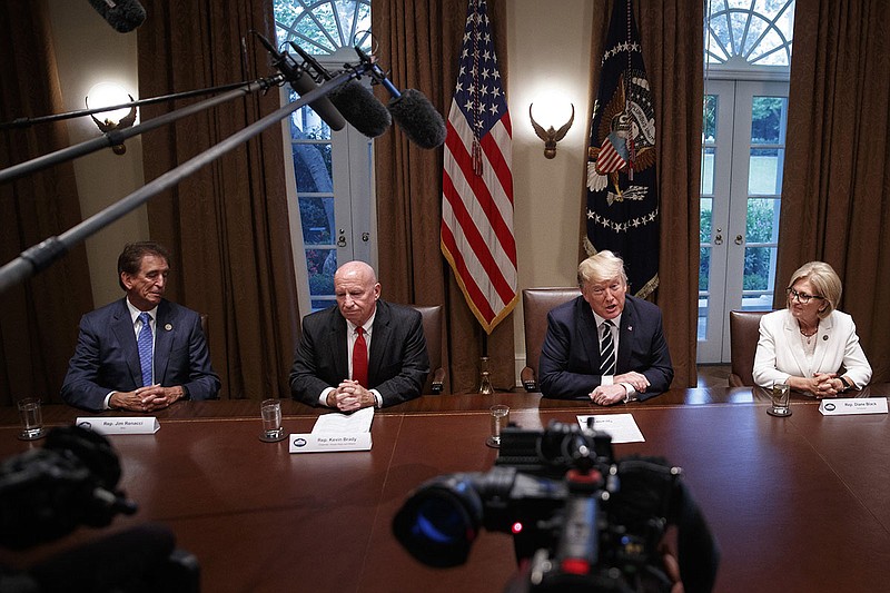 President Donald Trump delivers remarks with members of Congress on Tuesday inside the Roosevelt Room of The White House in Washington. From left: Rep. Jim Renacci, R-Ohio; Rep. Kevin Brady, R-Texas; Trump and Rep. Diane Black, R- Tenn. (Tom Brenner/ For The New York Times)
