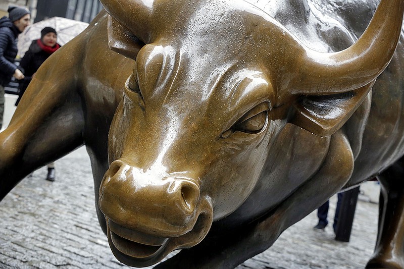 This Feb. 7, 2018, file photo shows The Charging Bull sculpture by Arturo Di Modica, in New York's Financial District.  Many along Wall Street expect the bull market rally that began in March 2009 to eclipse the 1990-2000 run that ended with the dot-com crash. But more voices are questioning whether the stock market's run will make it beyond 2019 or 2020.  (AP Photo/Richard Drew, File)