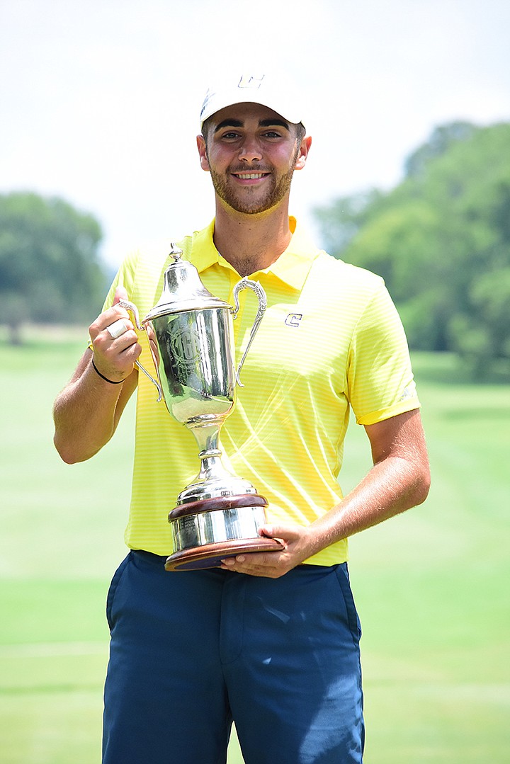 TGA photo / UTC and former Baylor School golfer Oliver Simonsen shows off the Tennessee Match Play trophy he won Thursday at Council Fire.