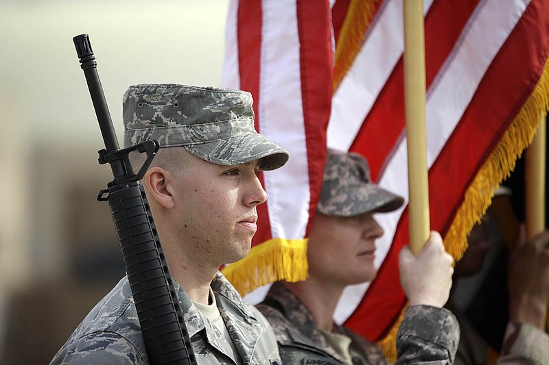 US Army soldiers stand during ceremonies marking the end of US military mission in Baghdad, Iraq, Thursday, Dec. 15, 2011. After nearly nine years, 4,500 American dead, 32,000 wounded and more than $800 billion, U.S. officials formally shut down the war in Iraq a conflict that U.S. Defense Secretary Leon Panetta said was worth the price in blood and money, as it set Iraq on a path to democracy. (AP Photo/Khalid Mohammed)