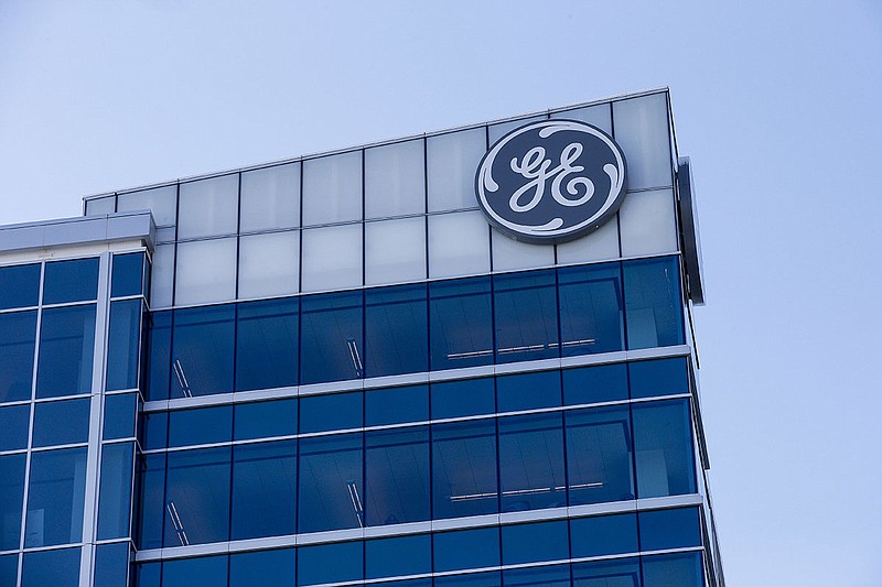 In this Jan. 16, 2018, photo, the General Electric logo is displayed at the top of their Global Operations Center in the Banks development of downtown Cincinnati. General Electric Co. reports earnings Friday, July 20. (AP Photo/John Minchillo, File)