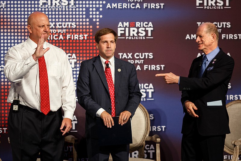 Staff photo by Doug Strickland / Senior Policy Advisor for America First Curtis Ellis, right, points to U.S. Reps. Scott DesJarlais, left, and Chuck Fleischmann as they join a panel discussion at a tax policy event hosted by America First policies at Lee University's Pangle Hall on Saturday, July 21, 2018, in Cleveland, Tenn. Vice President Mike Pence was the keynote speaker at the event, which featured a panel of guests discussing the effects of President Donald Trump's tax bill.
