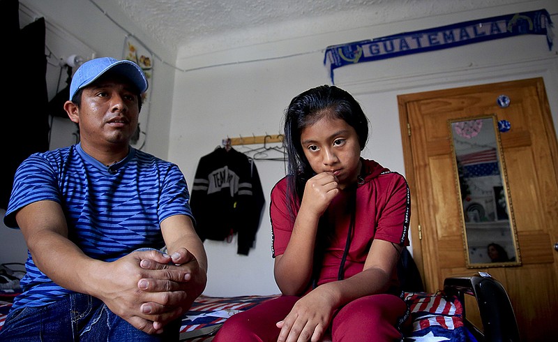 Manuel Marcelino Tzah, left, and his daughter Manuela Adriana, 11, sit inside their apartment during an interview hours after her release from immigrant detention, Wednesday July 18, 2018, in Brooklyn borough of New York. 