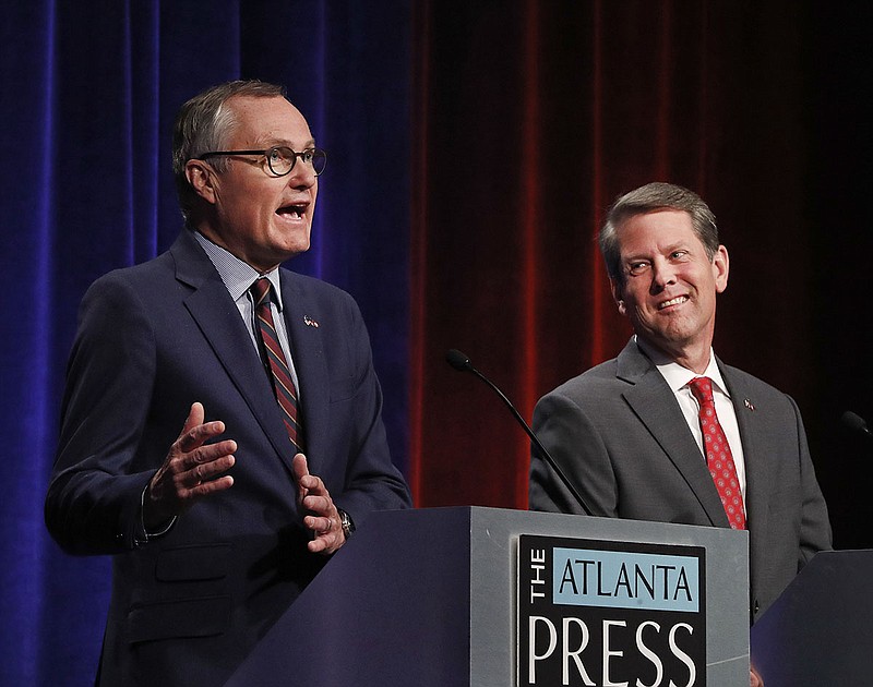 In this July 12, 2018, photo, Republican candidates for Georgia Governor Georgia Lt. Gov. Casey Cagle, left, and Secretary of State Brian Kemp speak during an Atlanta Press Club debate at Georgia Public Television  in Atlanta. The two will face each other July 24 in a runoff election for the Republican nomination. (AP Photo/John Bazemore)
