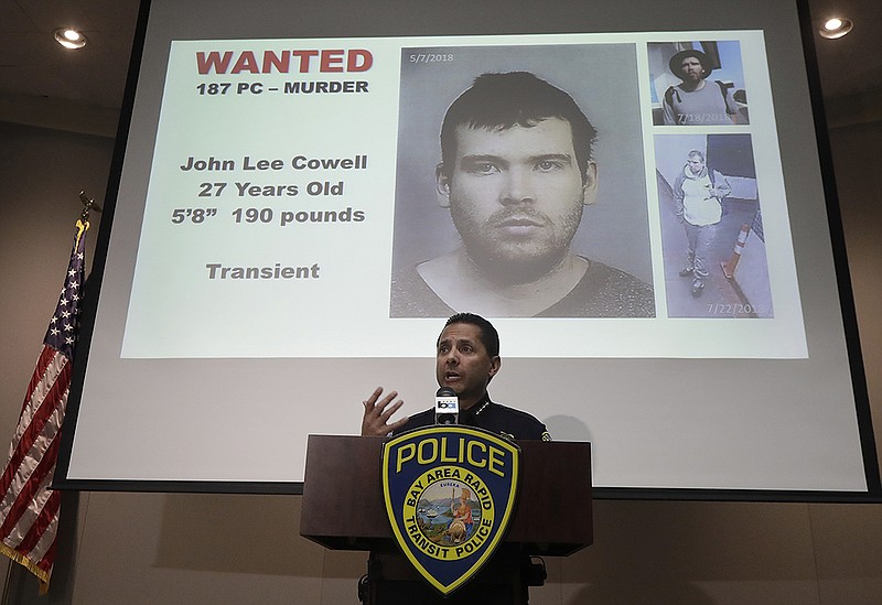 Bay Area Rapid Transit Police Chief Carlos Rojas speaks at a news conference in front of images of John Lee Cowell, a suspect wanted in the stabbings of two women at a BART station, in Oakland, Calif., Monday, July 23, 2018.