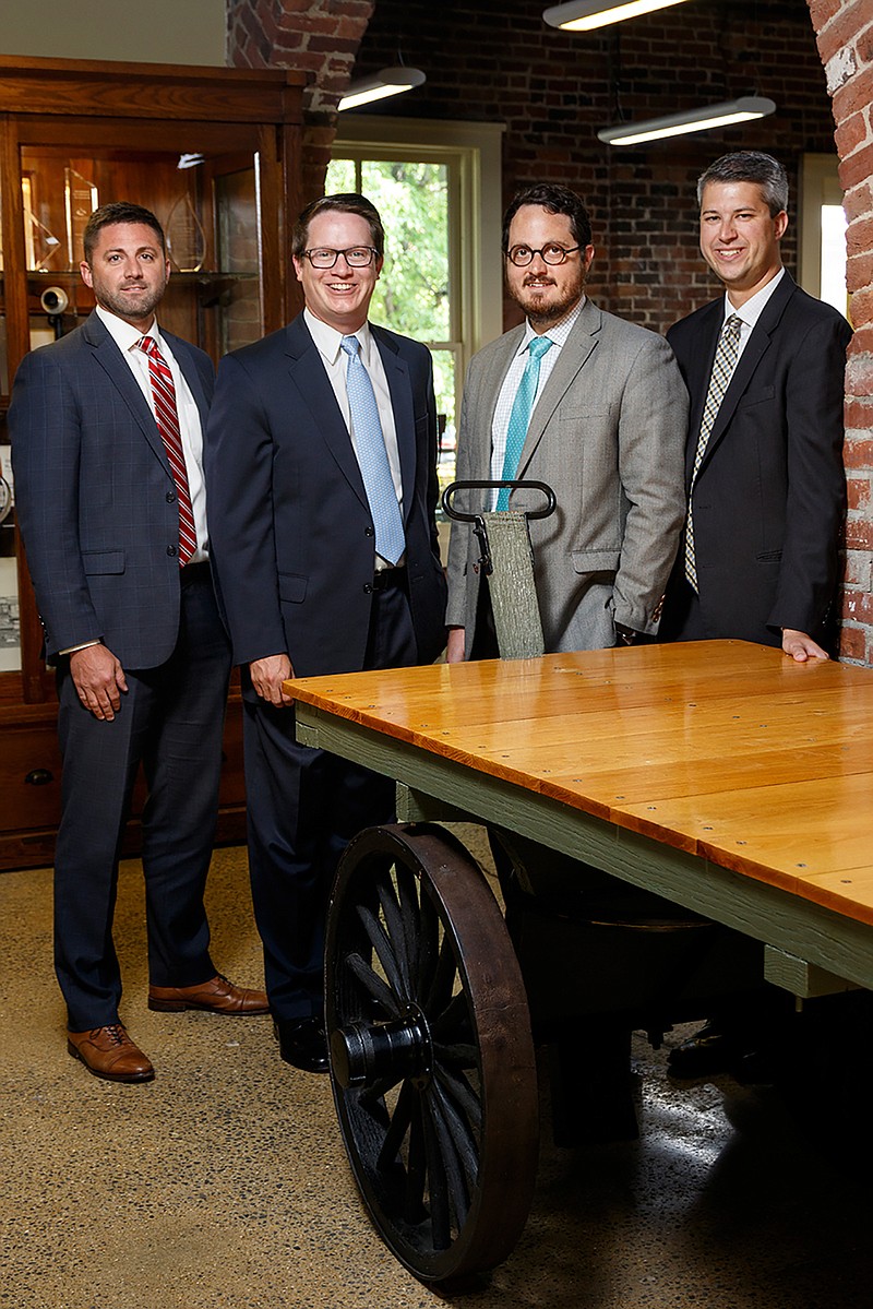 New Henderson, Hutcherson and McCullough CPA partners Branden Wilson, Will Clegg, Jon Paul Davis and Adam Osborne, from left, pose for a portrait in their offices on Friday, July 13, 2018, in Chattanooga, Tenn. 
