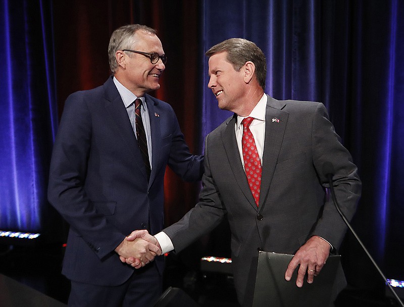 In this July 12, 2018, file photo, Georgia Republican gubernatorial candidates, Lt. Gov. Casey Cagle, left, and Secretary of State Brian Kemp shake hands after an Atlanta Press Club debate at Georgia Public Television in Atlanta. The two will face each other July 24 in a primary runoff for the Republican nomination. (AP Photo/John Bazemore, File)