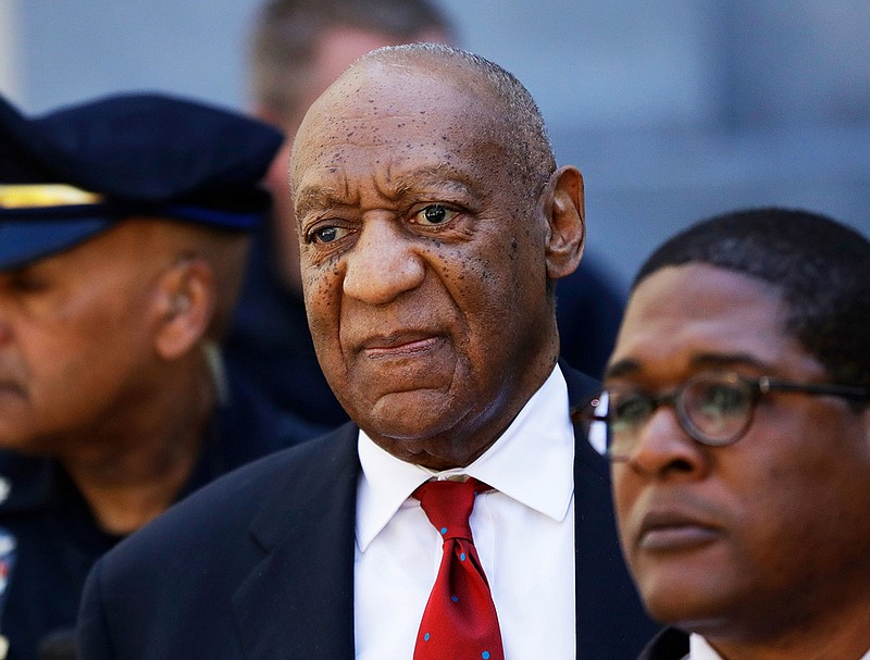 In this April 26, 2018 file photo, Bill Cosby, center, leaves the the Montgomery County Courthouse in Norristown, Pa. A representative from the Sexual Offenders Assessment Board has issued an assessment recommending that Bill Cosby be classified as a sexually violent predator. Cosby, 81, was convicted April 26 on sexual assault charges related to accusations he had drugged and assaulted Andrea Constand in his home in 2004. He is scheduled for sentencing on Sept. 24. (AP Photo/Matt Slocum, File)
