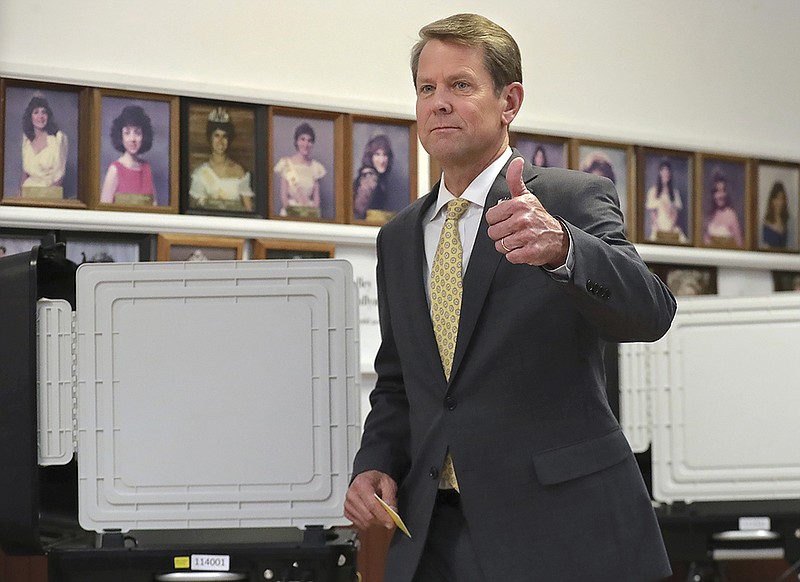 Georgia Secretary of State Brian Kemp gives a thumbs up after casting his ballot while voting with his wife Marty at the Winterville Train Depot in the runoff election on Tuesday, July 24, 2018, in Winterville, Ga. 