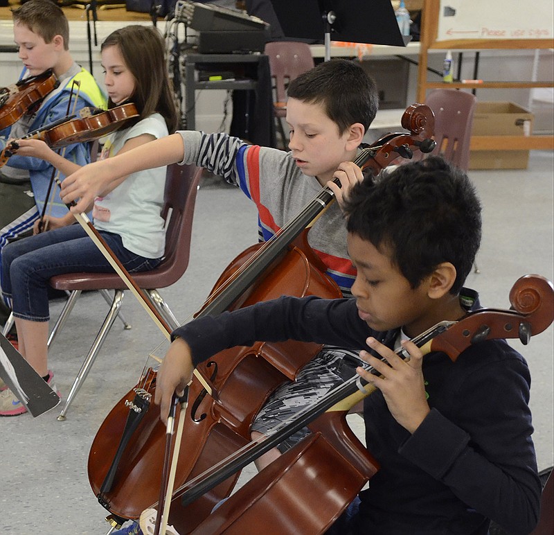 In this 2014 staff file photo, Jacob Chapman and John Paul Freeman, right, play cellos as they and other fifth graders participate in beginning strings class at the Chattanooga School for the Liberal Arts.