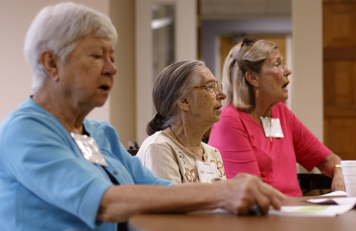 Volunteer Faye Jordan, center, sings along during the Let's Sing From Memory event at Northside Presbyterian Church.