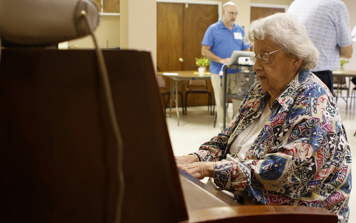 Peggy Rhodes plays the piano during the Let's Sing From Memory event.