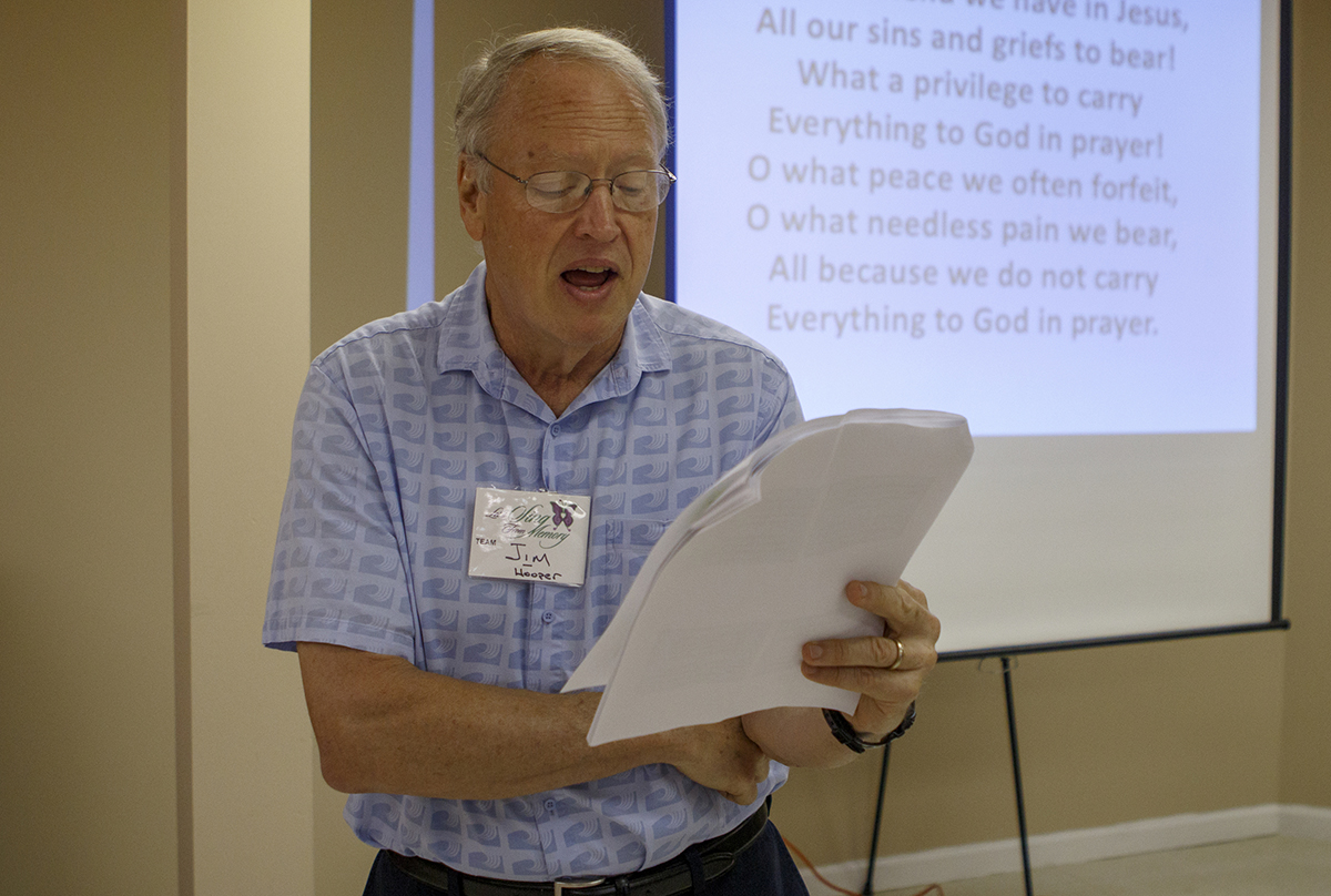 Jim Hooper leads the group gathered for the Let's Sing From Memory event in