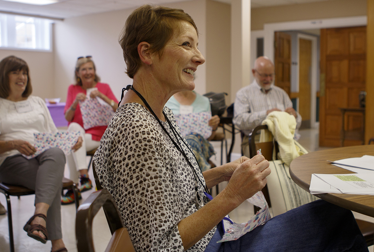 Dawn Edens plays with bubble wrap during the Let's Sing From Memory event at Northside Presbyterian Church. Bubble wrap was passed out to those in attendance for a little bit of fun and as a way to soothe arthritic fingers.
