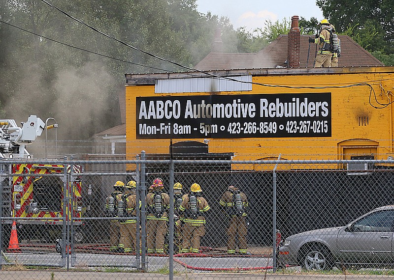 Chattanooga firefighters work to put out a fire at AABCO Automotive Rebuilders Thursday, July 26, 2018, in Chattanooga, Tennessee. More than 10 firetrucks were on scene with firefighters rotating out as needed. 