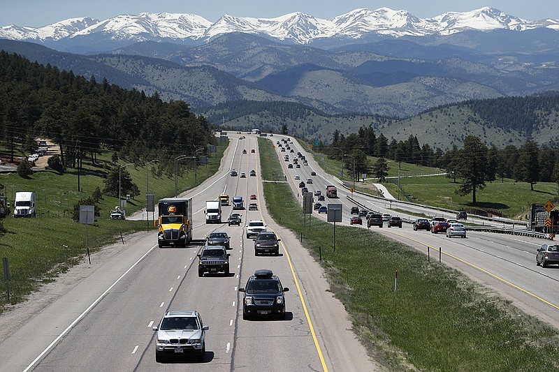 In this May 25, 2018, file photo, motorists guide their vehicles down Interstate 70 near Evergreen, Colo. Drivers expect insurance companies to offer digital experiences on par with the likes of Amazon, Uber and Netflix. Insurers are far from meeting those expectations, but they're stepping up their game in the battle for customers. Today, auto insurance companies are using technology to change how they set prices, give discounts, answer common questions and handle claims. (AP Photo/David Zalubowski, File)