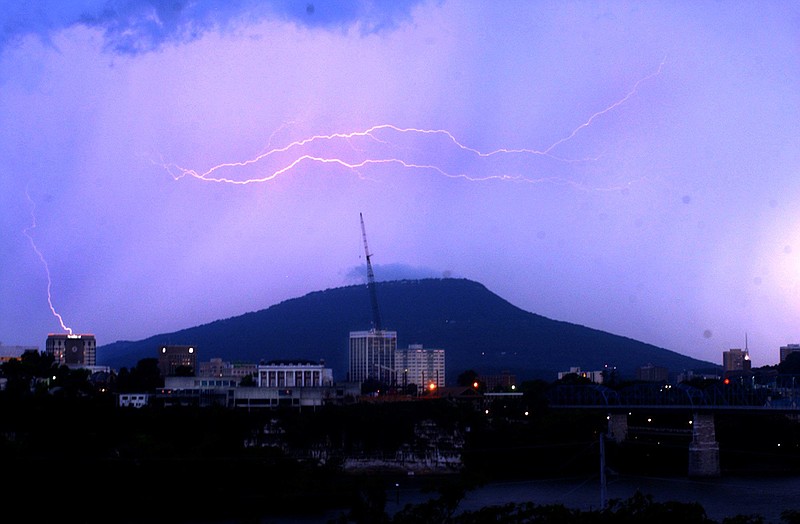 Lightning bolts span the top of Lookout Mountain Wednesday evening as a storm cloud move west to east over Chattanooga. A single bolt appears to strike the SunTrust building, at left.