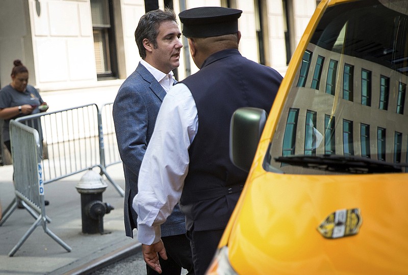 Michael Cohen, formerly a lawyer for President Trump, leaves his hotel on Thursday in New York. Cohen is reportedly prepared to share information related to Russia's meddling in the 2016 Presidential election. (AP Photo/Kevin Hagen)