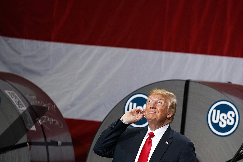 President Donald Trump gestures as he arrives to deliver remarks on trade at Granite City Works Steel Coil Warehouse on Thursday in Granite City, Ill. (AP Photo/Evan Vucci)