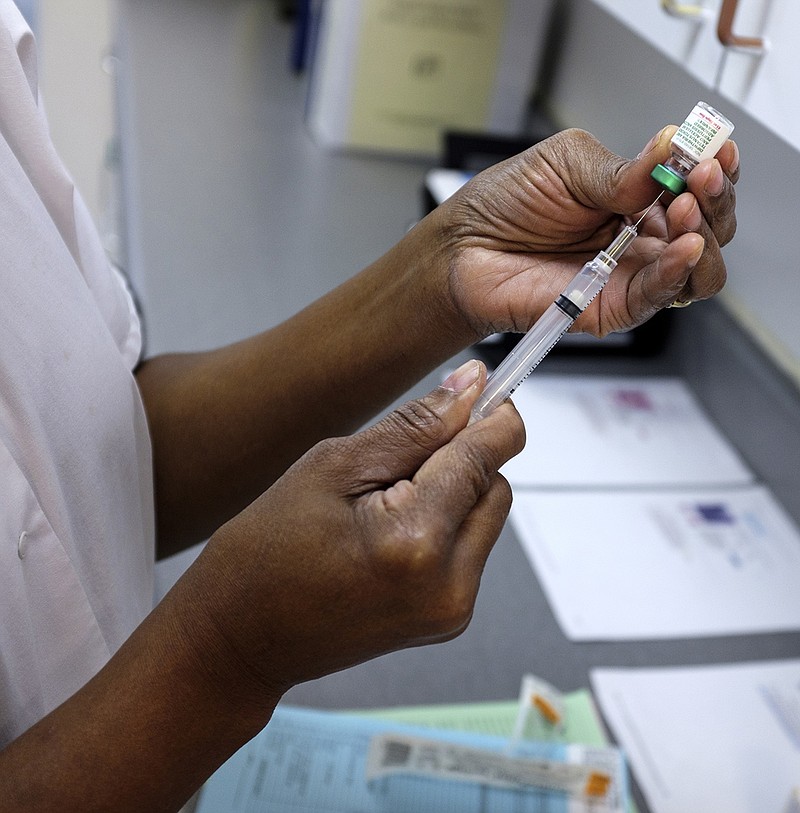 Nurse Diani Jones prepares a vaccine at the Hamilton County Health Department on July 29, 2015.