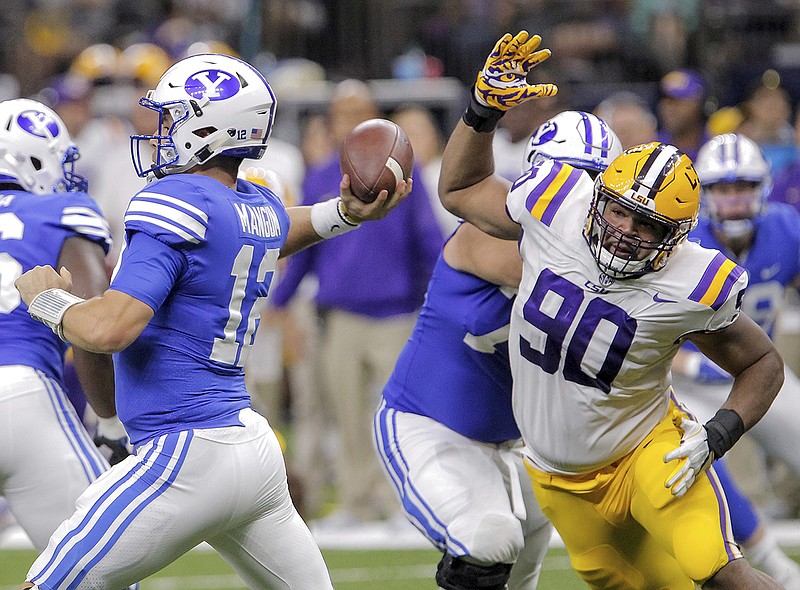 LSU defensive end Rashard Lawrence closes in on BYU quarterback Tanner Mangum during last September's 27-0 win by the Tigers.