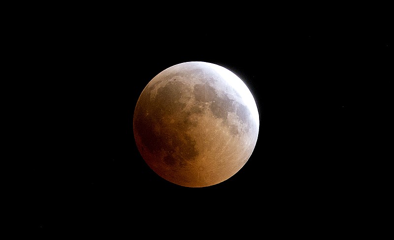 A blood moon rises over Gaza City, Friday, July 27, 2018. Skywatchers around much of the world are looking forward to a complete lunar eclipse that will be the longest this century. The so-called "blood moon" Friday, when it turns a deep red, will be visible at different times in Australia, Africa, Asia, Europe and South America when the sun, Earth and moon line up perfectly, casting Earth's shadow on the moon. (AP Photo/Hatem Moussa)